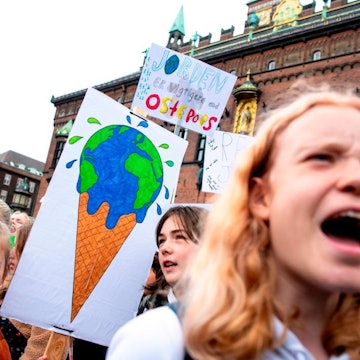 Young people hold signs in central Denmark.