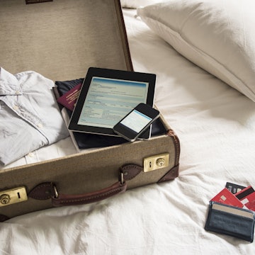 Open suitcase, ipad, phone and passport.jpg