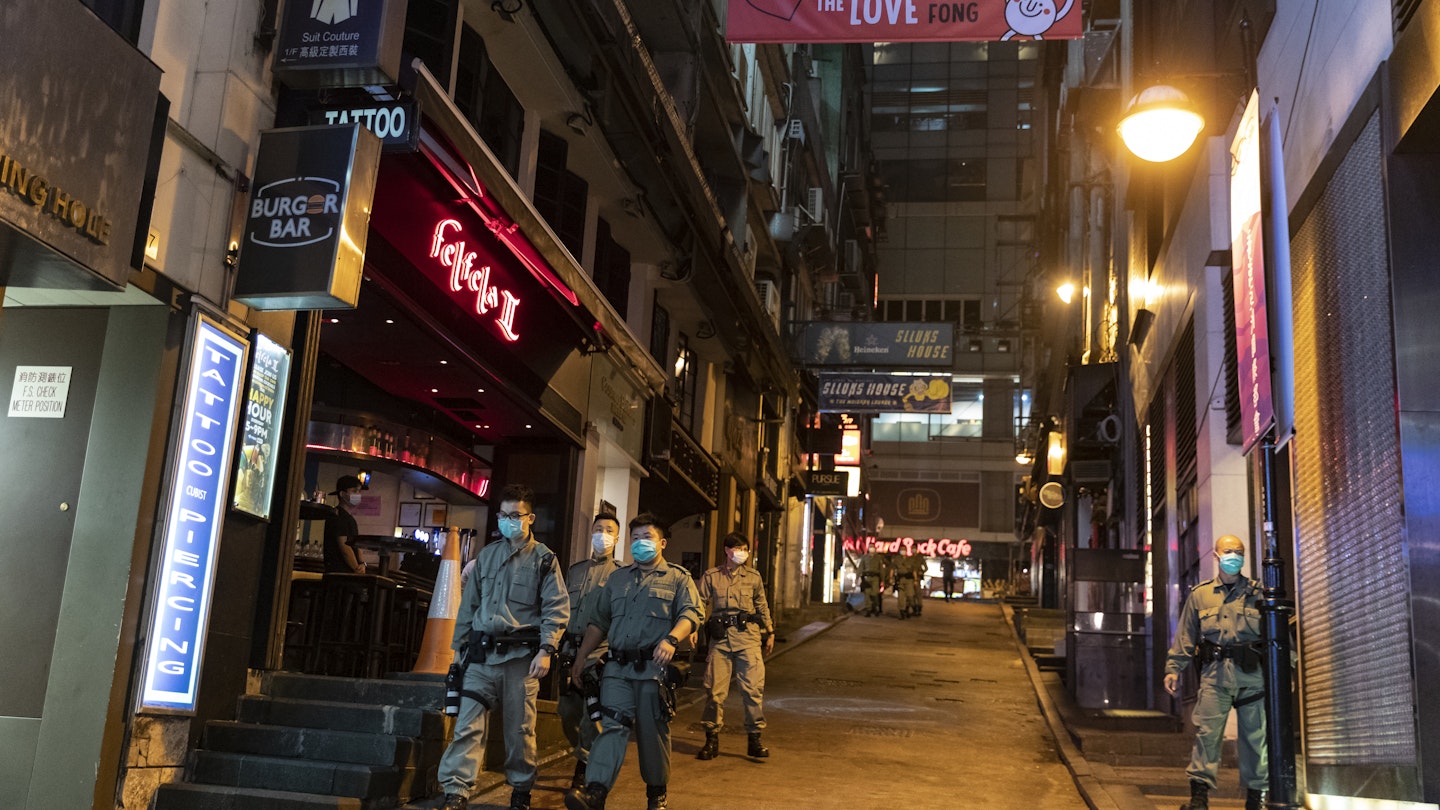 Police officers patrol around the Lan Kwai Fong area of Hong Kong 