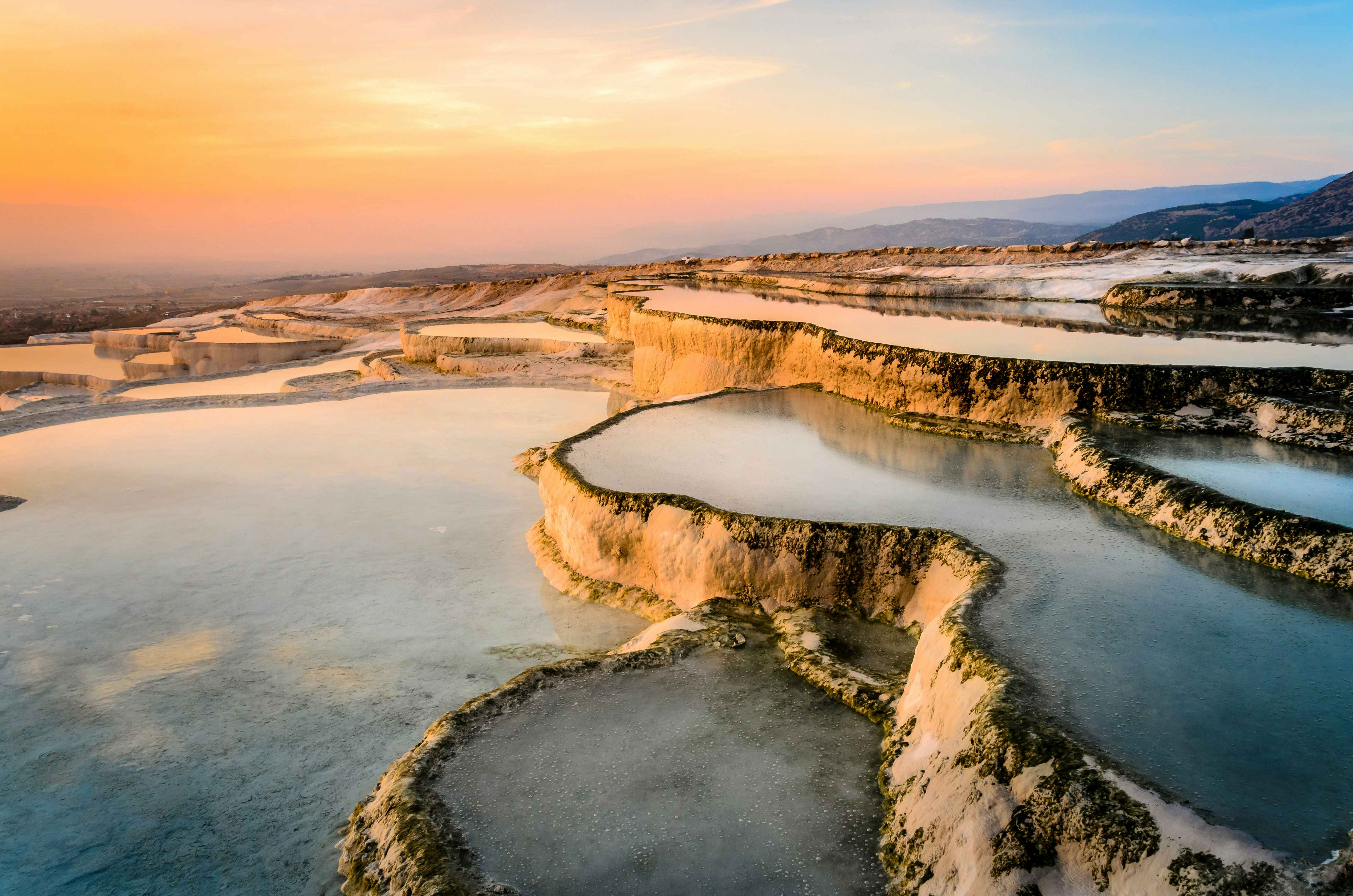 Carbonate travertines, natural pools during sunset, Pamukkale, Turkey © THANAN / Shutterstock