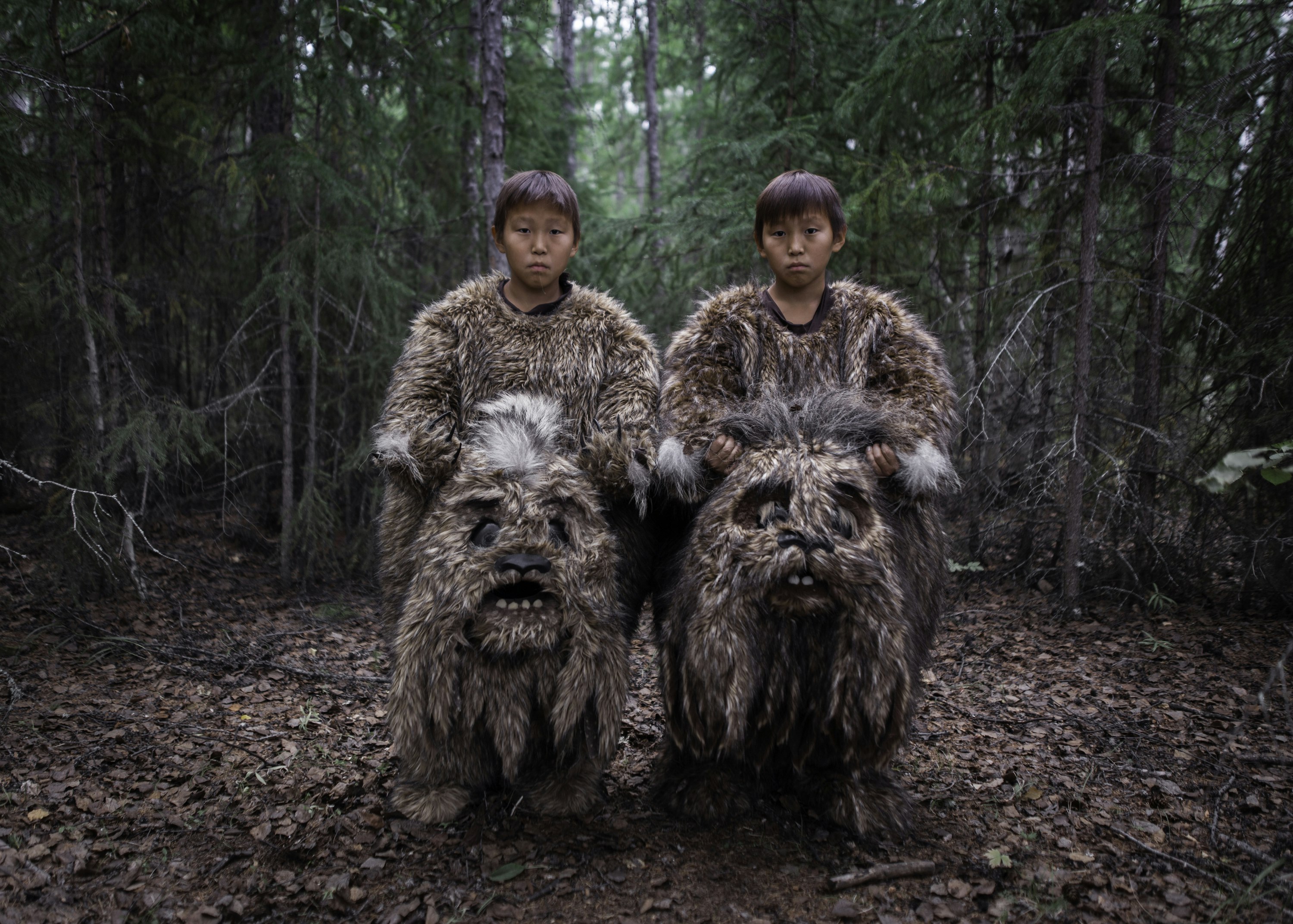 Two young boys dressed up in bear costumes