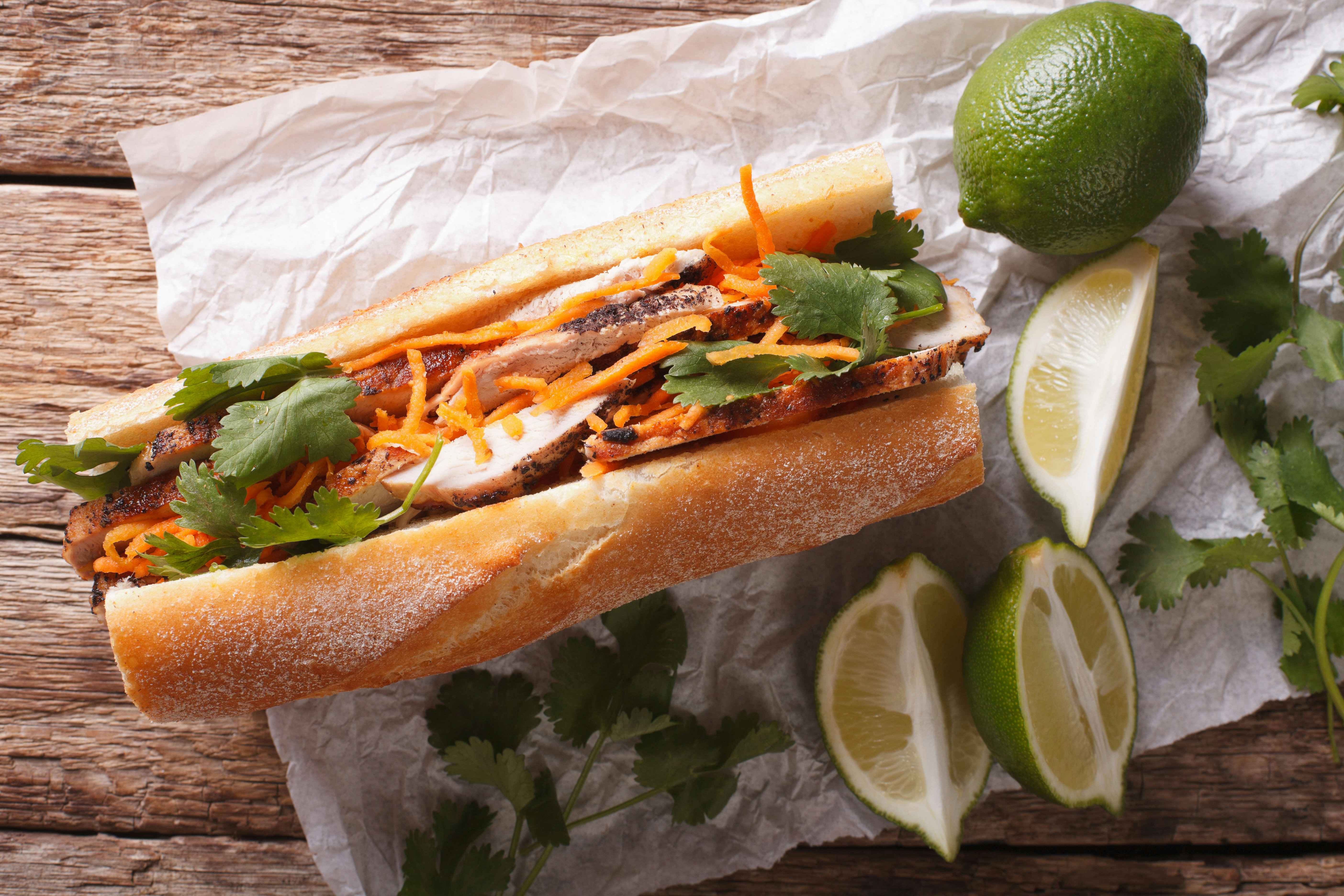 Vietnamese Pork Banh Mi Sandwich with Cilantro and carrot close-up on the table. horizontal view from above