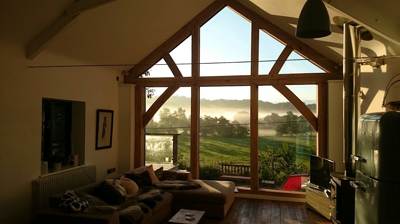 Views of the woods through windows in a barn in Devon