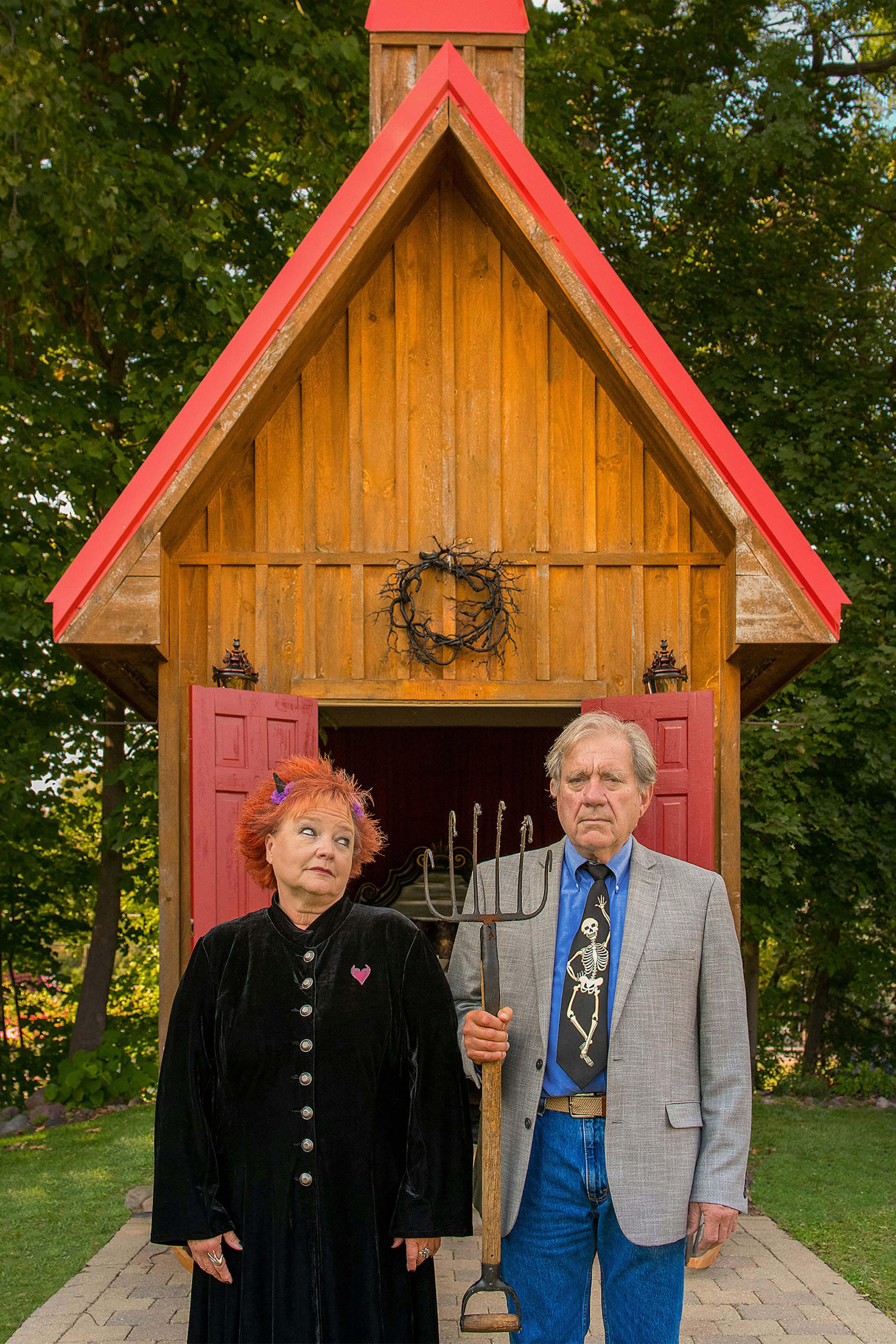 The mayor of Hell and his wife stand in front of their Airbnb property