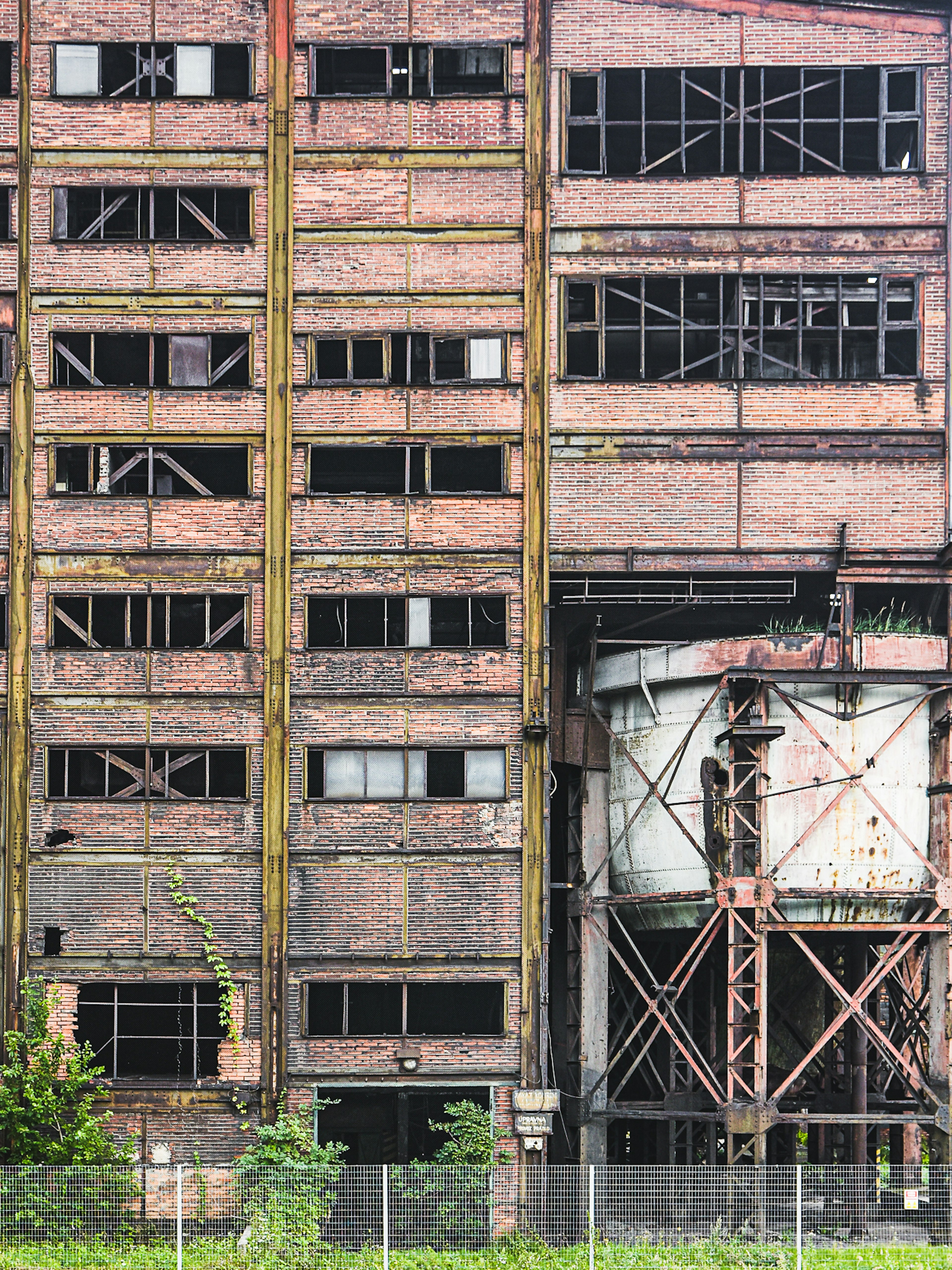 A close-up shot of brick warehouse buildings with smashed windows