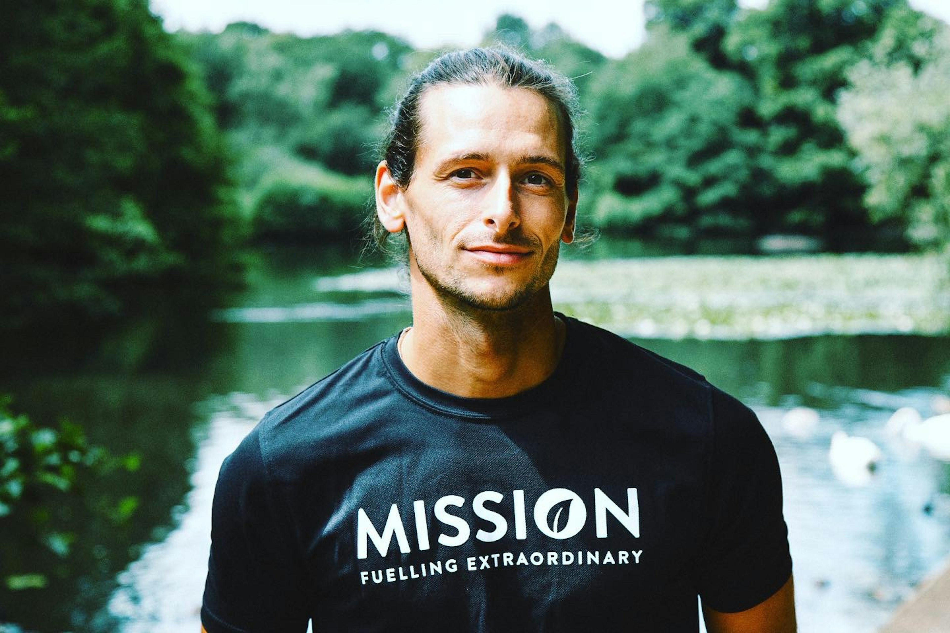 A portrait of a man in front of a lake