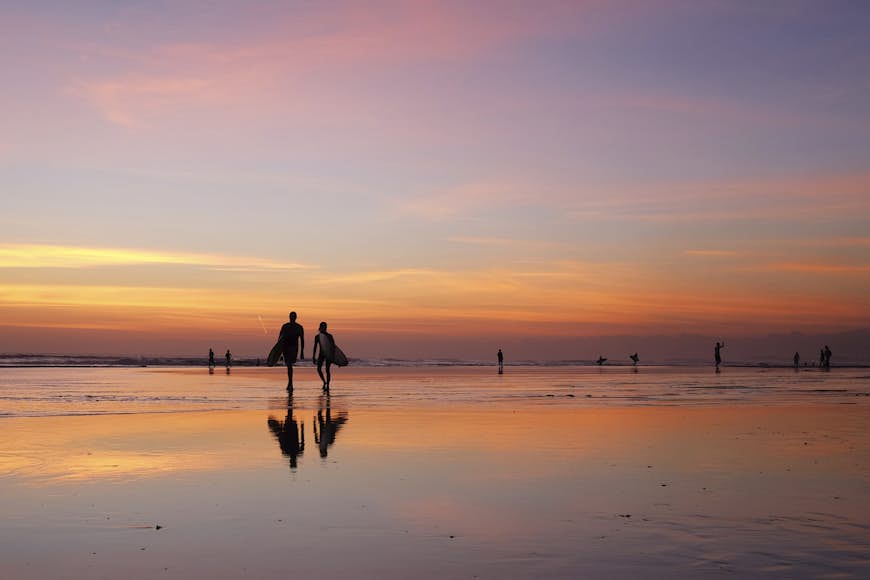 Silhouette of surfers on beach, Kuta, Bali, Indonesia 