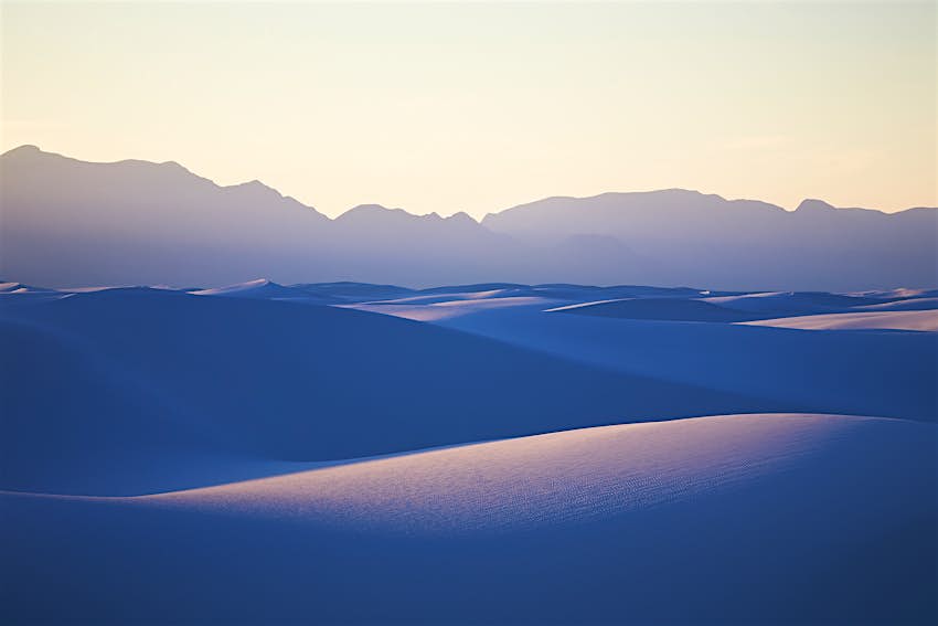 White sands rolling under a blue light