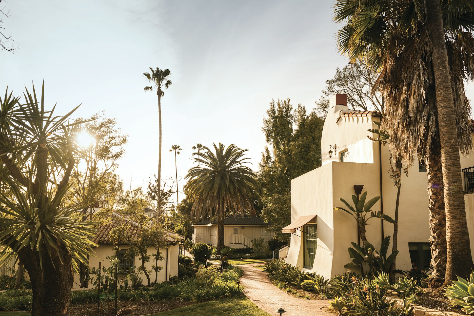 The Spanish Revival architecture of Belmond El Encanto, surrounded by palm trees