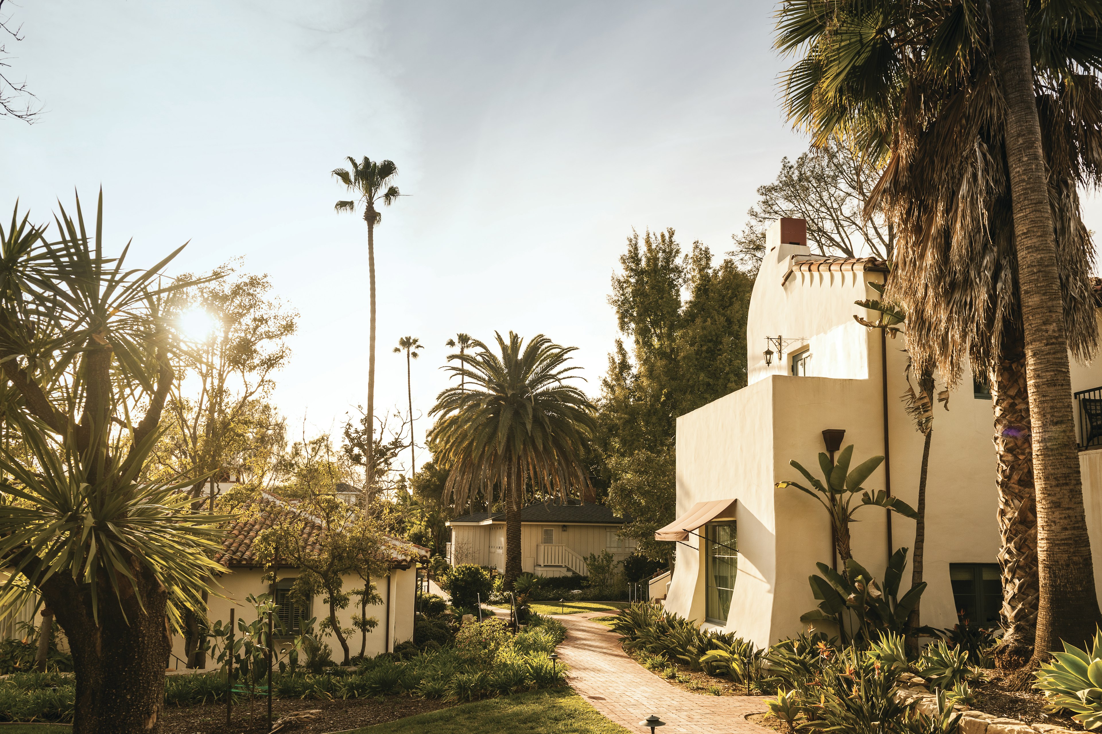 The Spanish Revival architecture of Belmond El Encanto, surrounded by palm trees