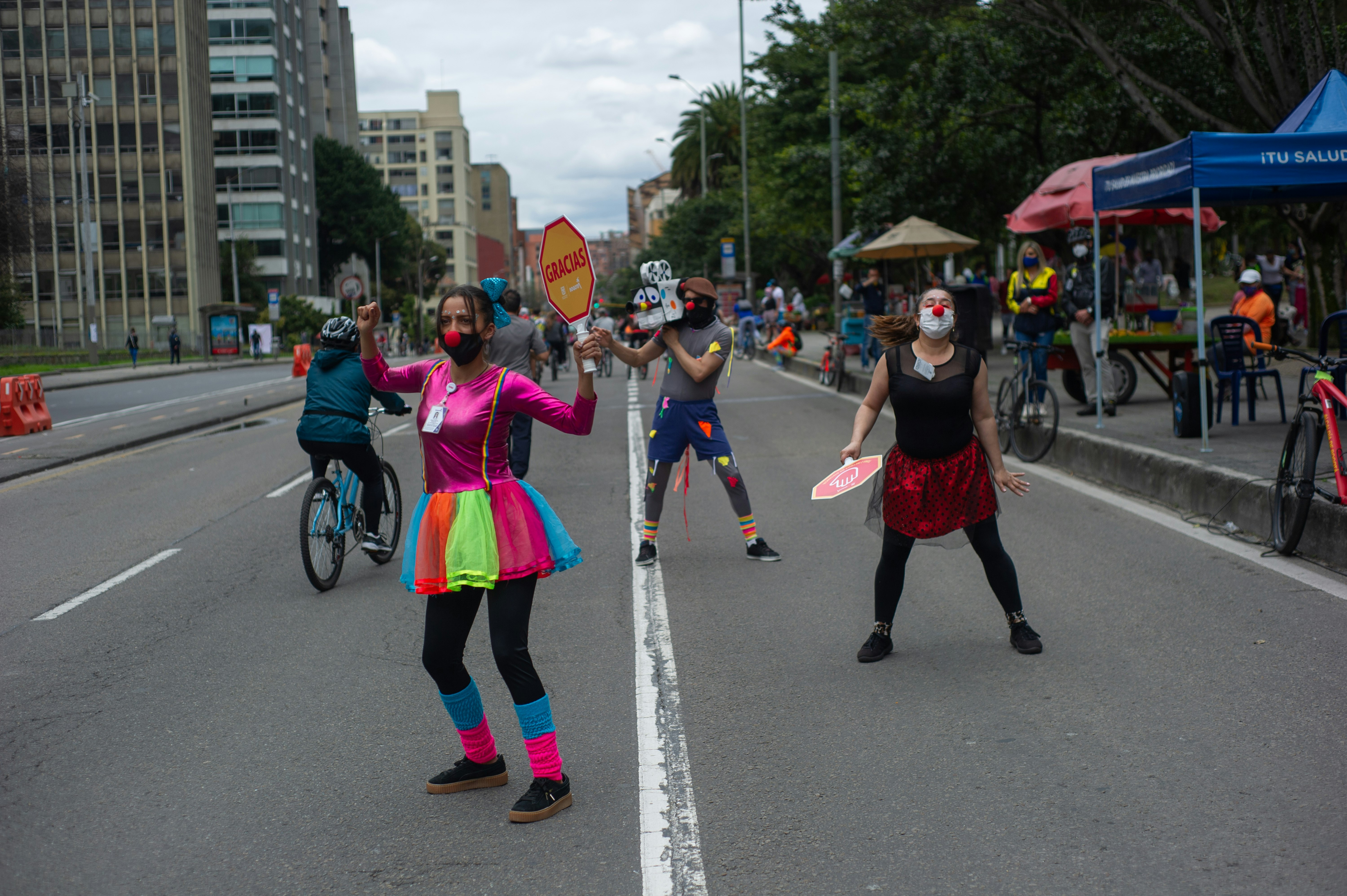 A group of performers dressed as clowns remember people to mantain social distancing and wear face masks in Bogota
