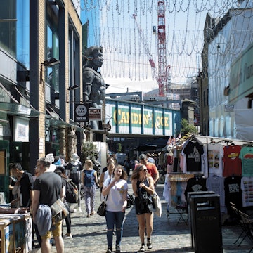 People shopping at Camden Market, with Camden Lock behind.