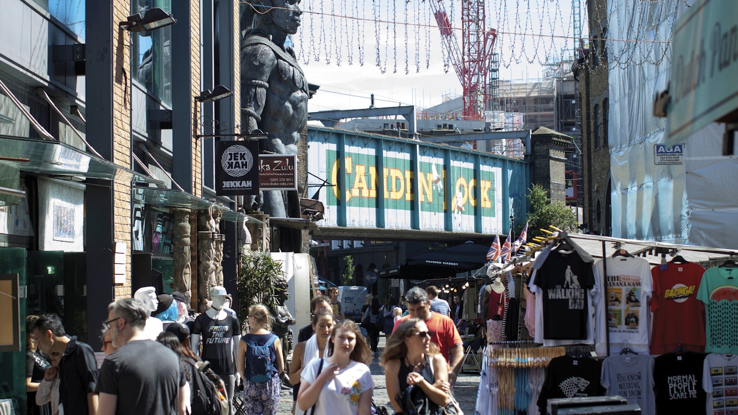 People shopping at Camden Market, with Camden Lock behind.