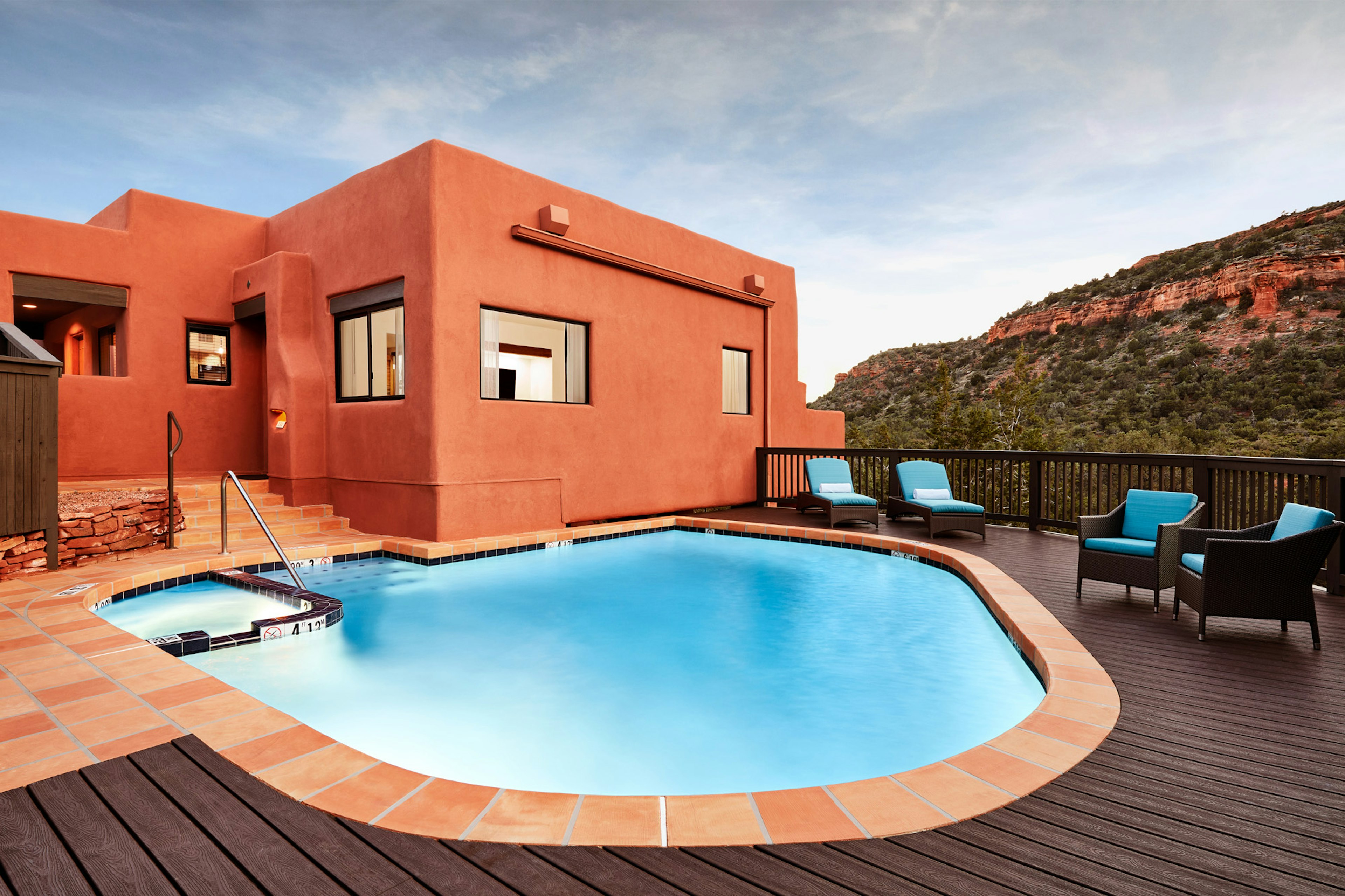 A pool among orange adobe style buildings