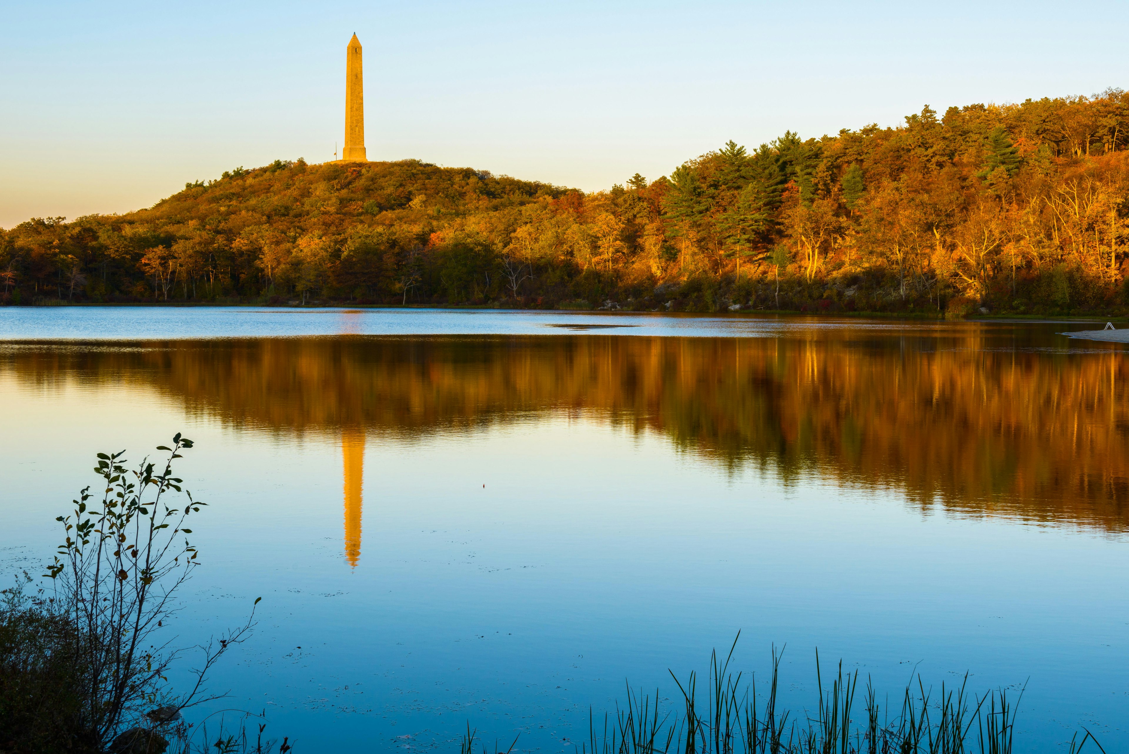 A war monument reflected in the lake on a fall evening at High Point State Park in New Jersey