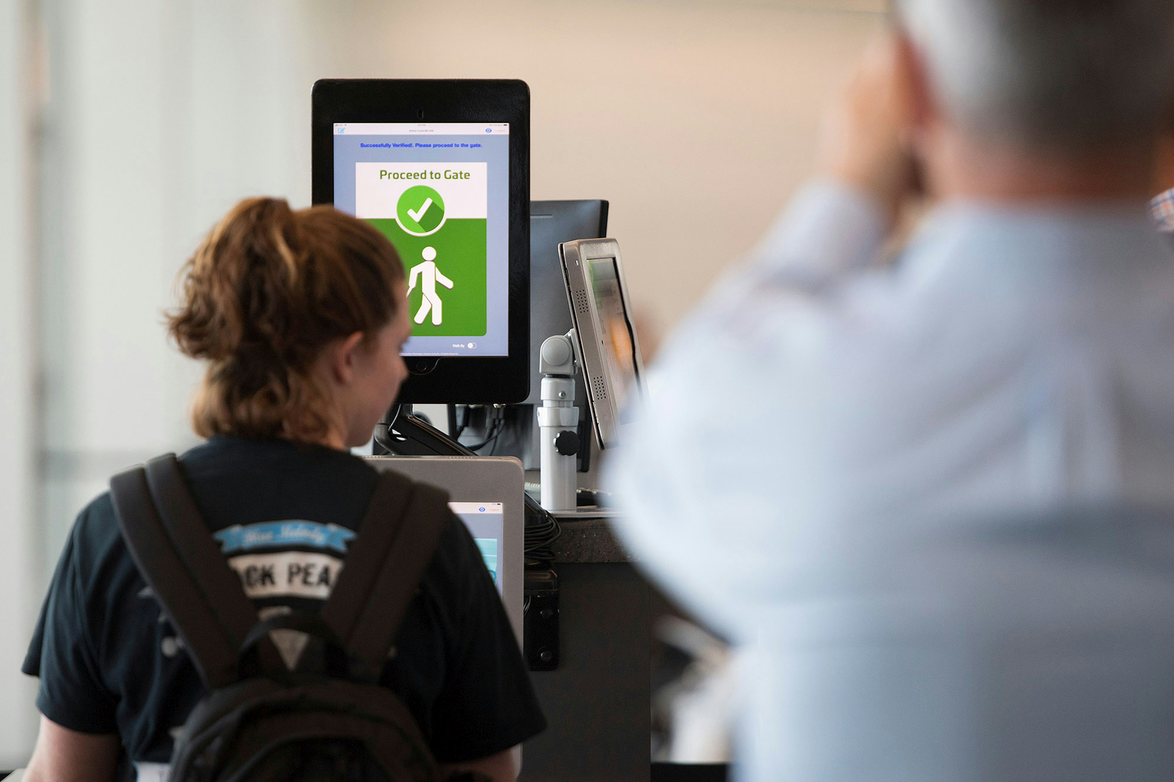 A woman boarding a SAS flight to Copenhagen goes through facial recognition verification system VeriScan at Dulles International Airport in Dulles, Virginia, on September 6, 2018. (Photo by Jim WATSON / AFP)        (Photo credit should read JIM WATSON/AFP via Getty Images)