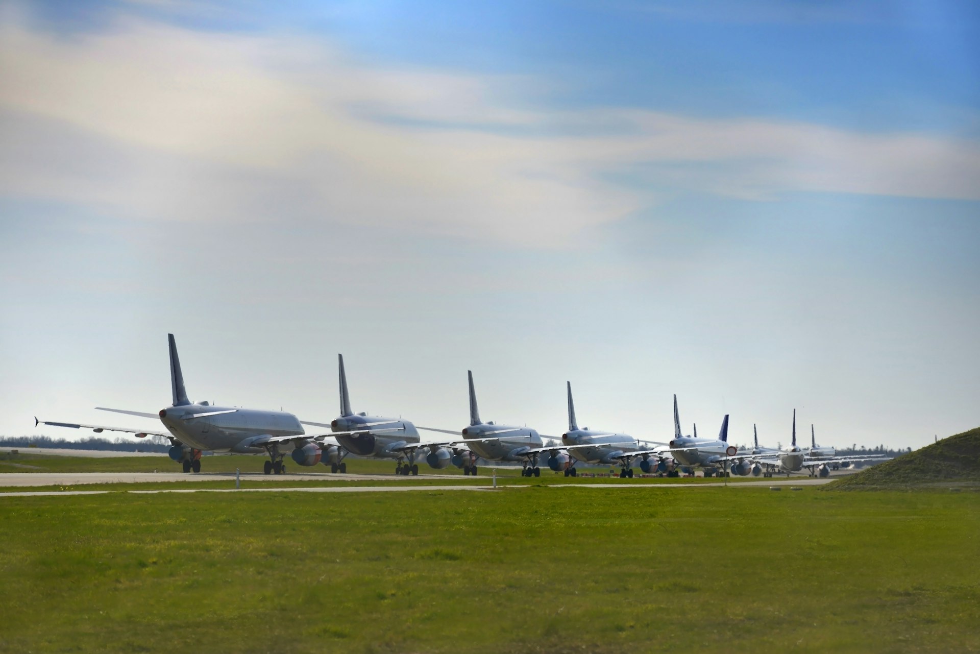 A line of aircraft parked at an airport