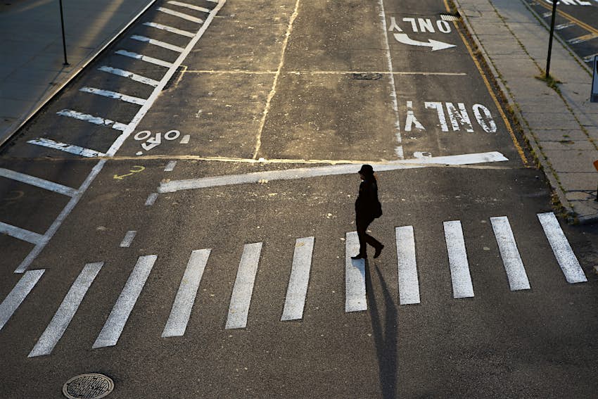A woman crossing a street in Dumbo, Brooklyn, New York City, USA A woman crossing a street in Dumbo, Brooklyn, New York City, USA