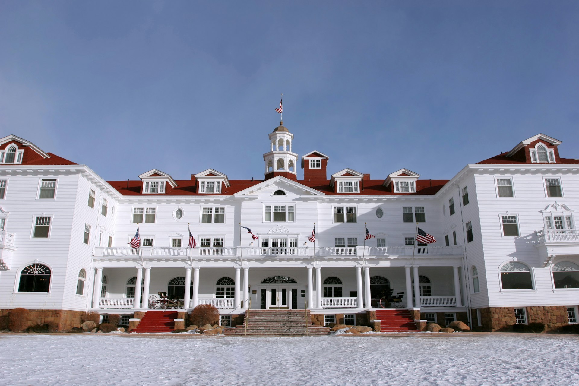 A large white hotel building with red-roof tiles and turrets