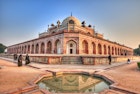 People walk around the outside of the Humayuns tomb.