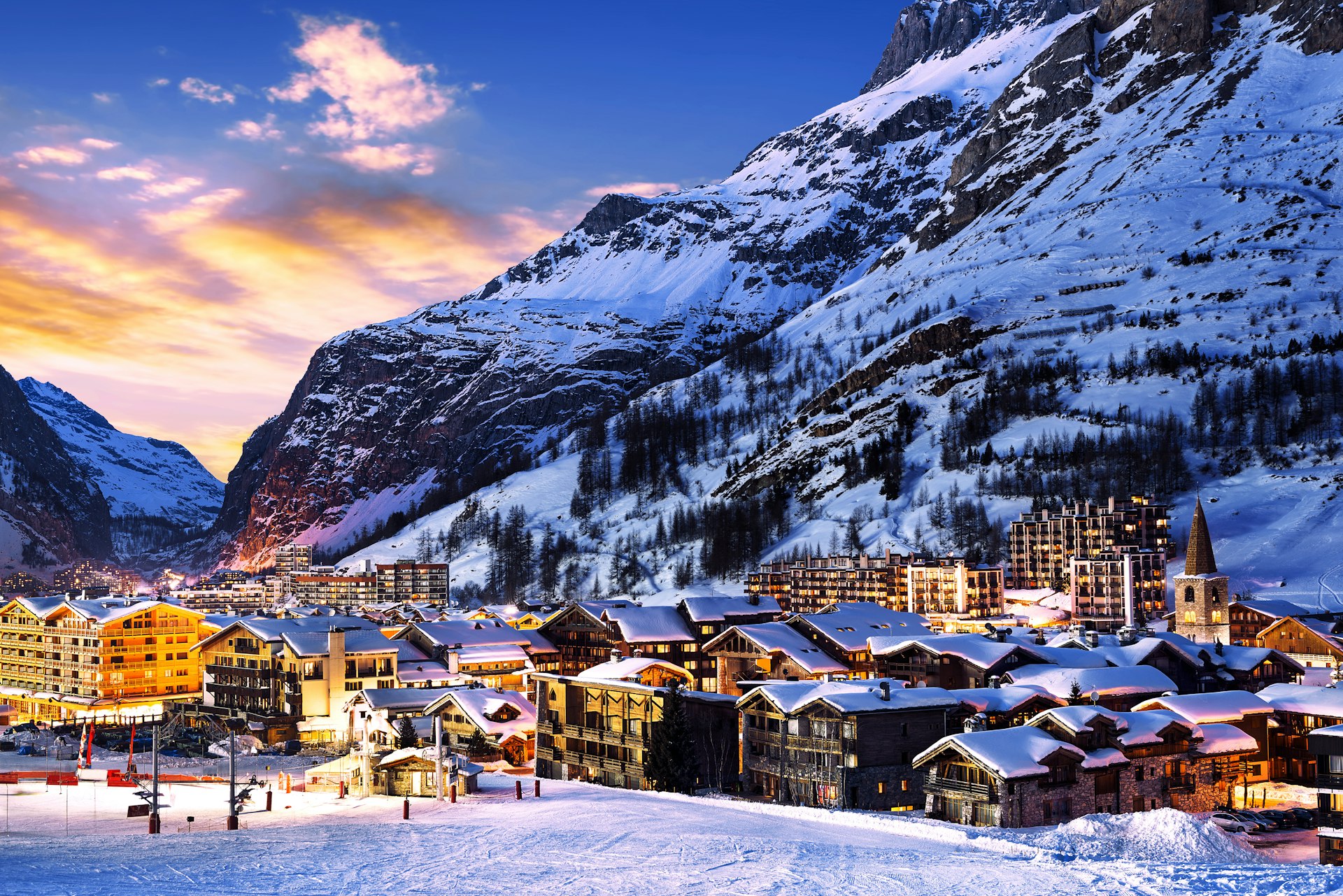 The town center of Val-d'Isere at dawn, with snow-covered roofs on ski lodges and chalets
