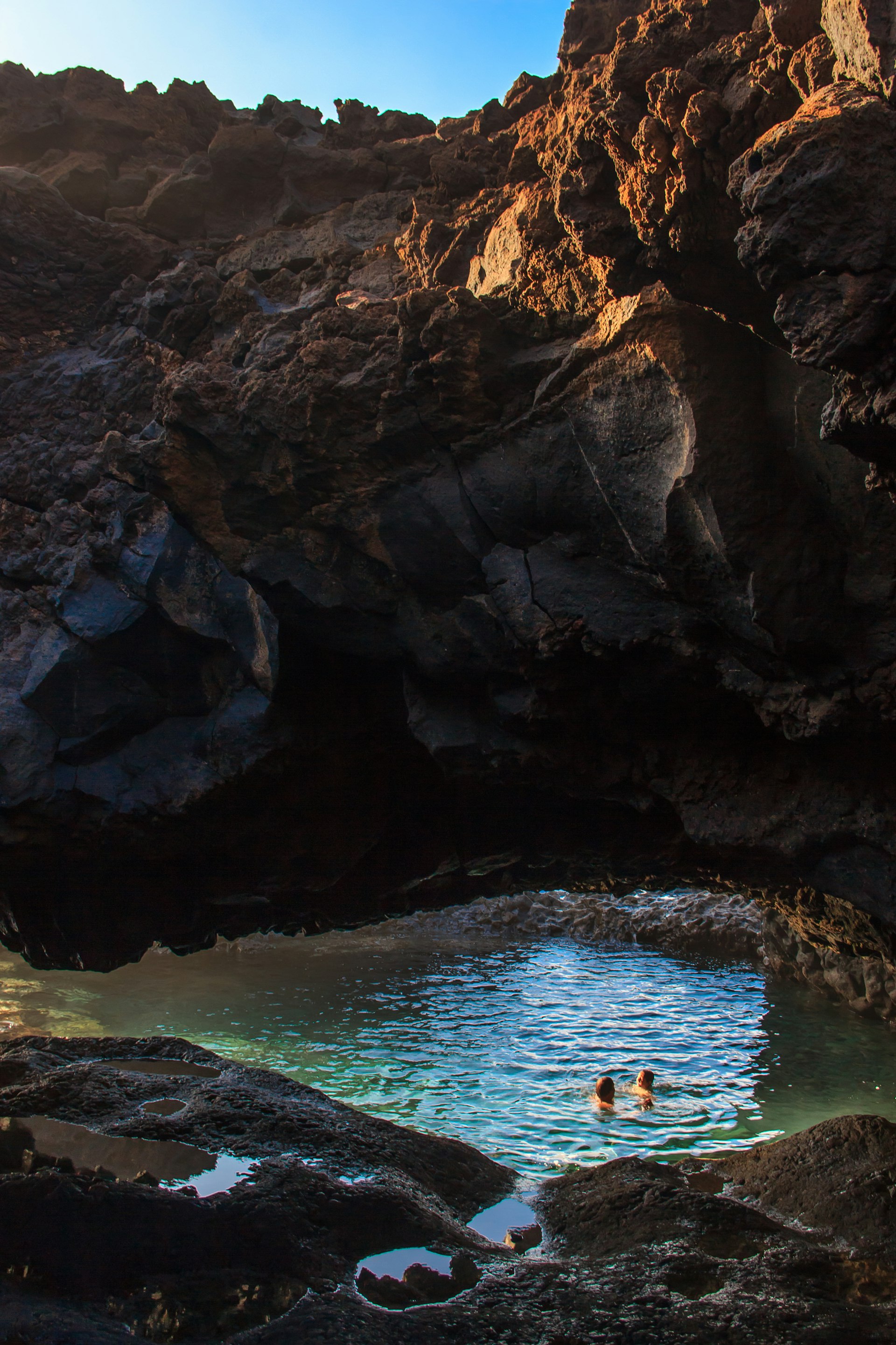 Bathers in Charco Azul, a natural volcanic pool in El Hierro, Canary Islands