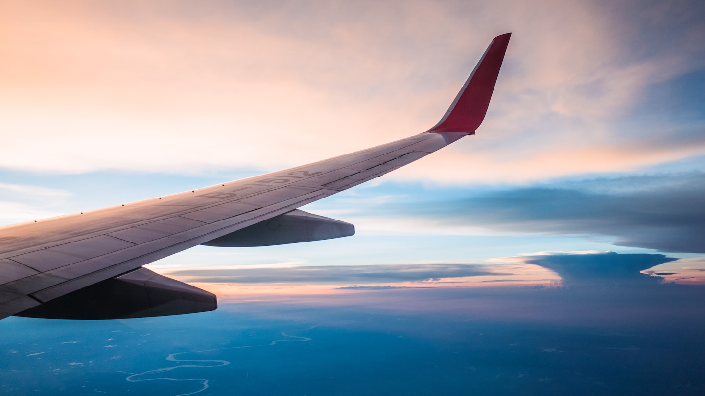 The wing of a plane flying over land in China.