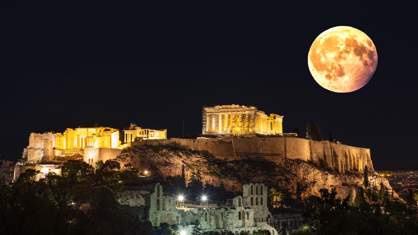 1 January 2018, Athens Greece: The Acropolis of Athens photographed from the nearby Pnyka, the place where ancient Athenians gathered to debate democracy. The picture is made in the full moon of January 2018. The main building in the picture is the Parthenon, dedicated to goddess Athena. In the foreground, the roman theater build by Heroδ can be seen