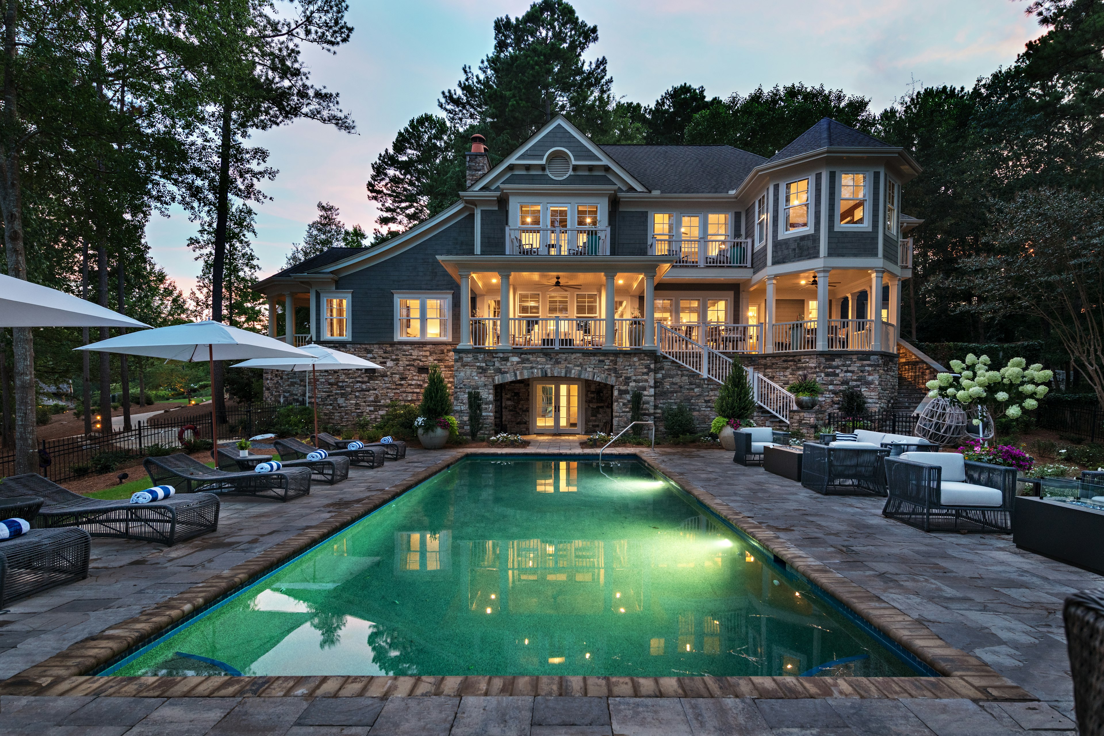 A large stone building with a swimming pool in front of it