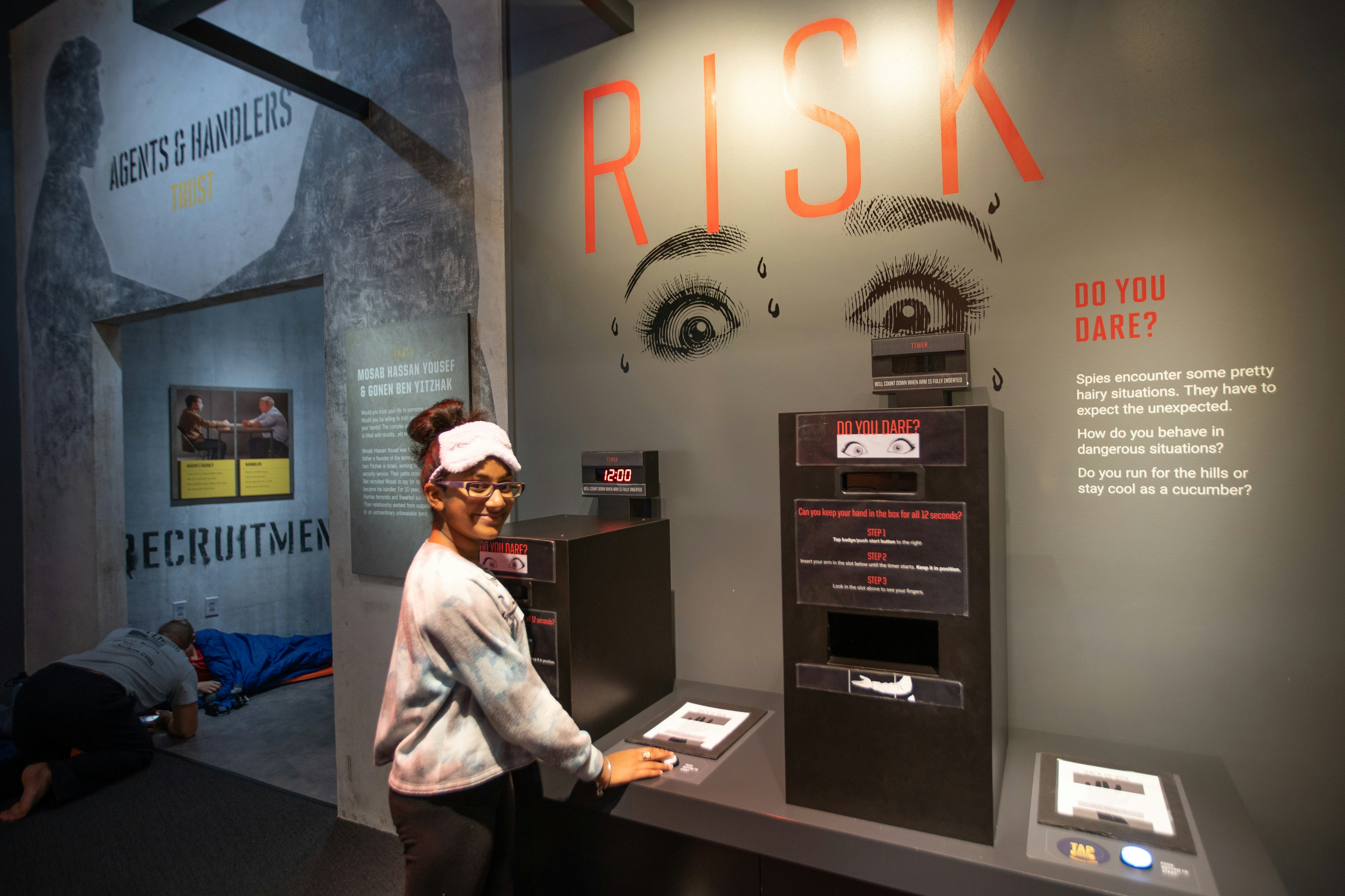 A young girl in a sleep mask at a museum sleepover