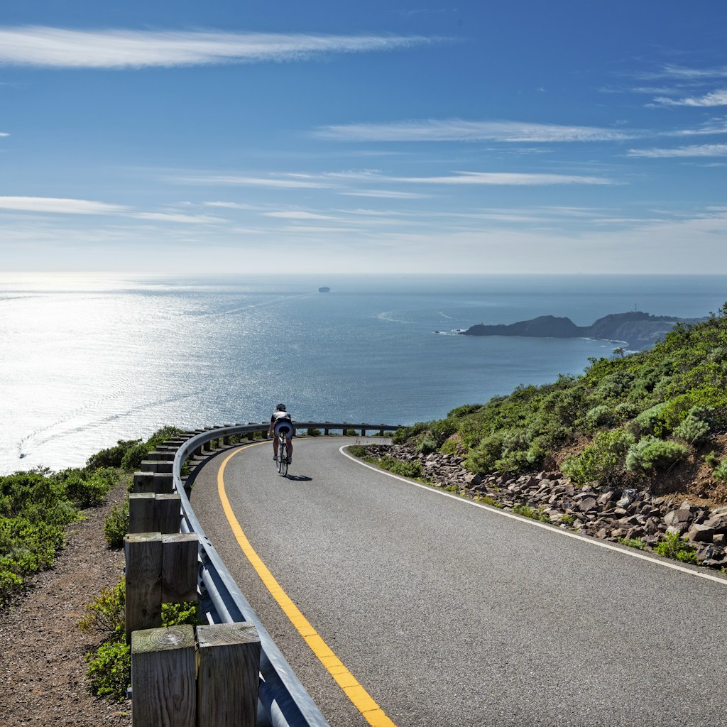 Road along the coastline in Marin Headlands , Cyclist