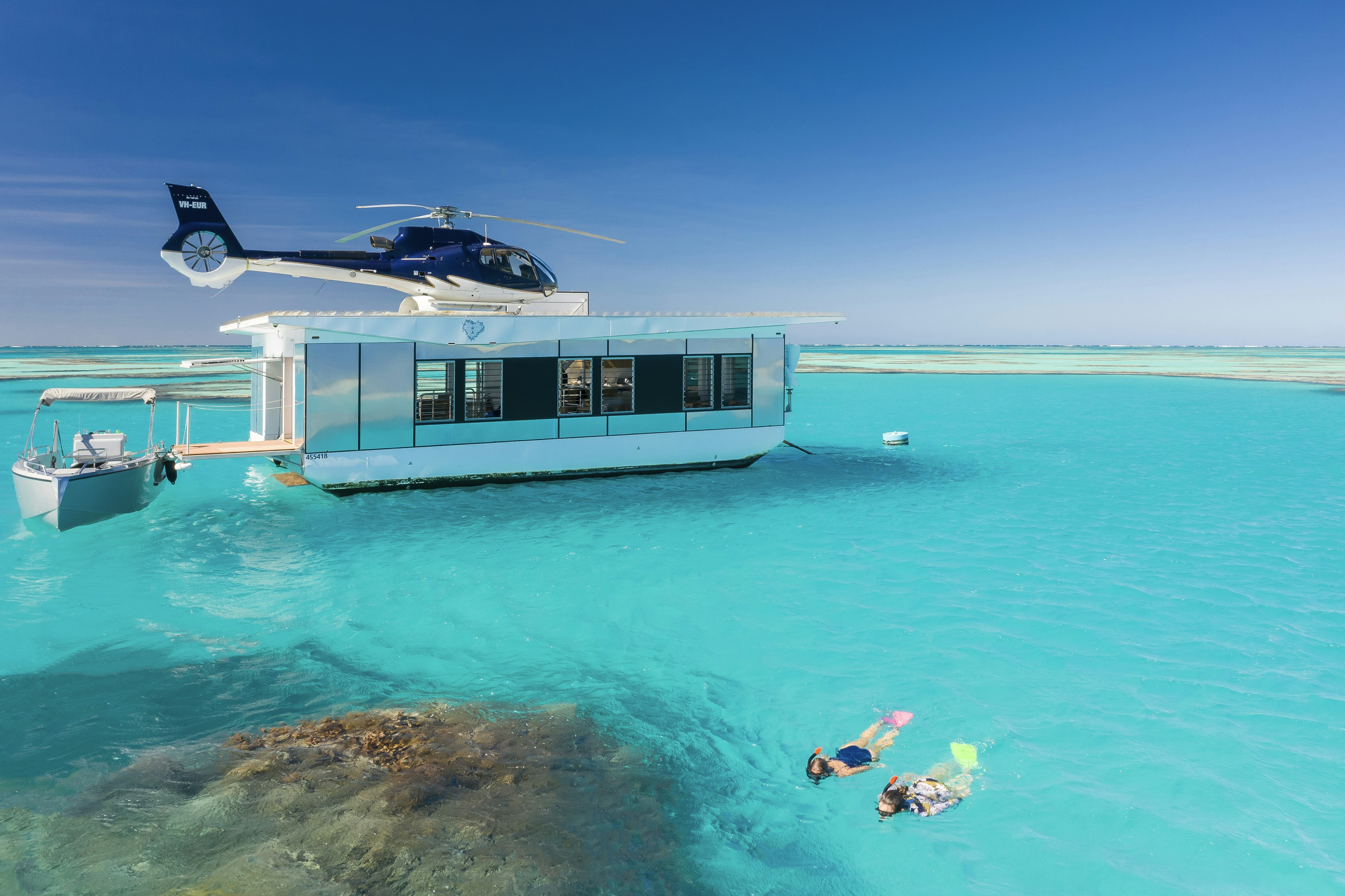 Snorkelers on Heart Reef, pontoon and helicopter in the background