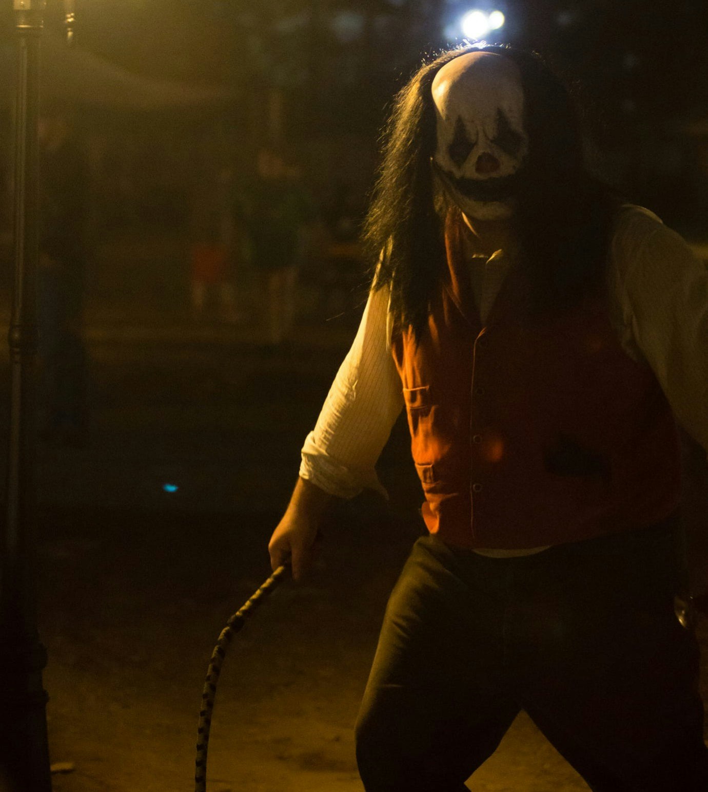 A scary character in a mask holding a whip in Terror Town