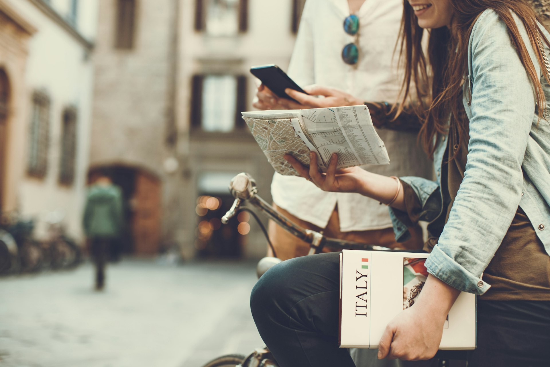 Tourists with guide and map in alleys of Italy