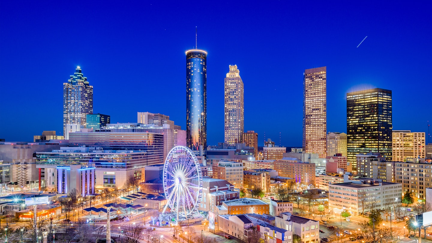 Downtown Atlanta city skyline lit up during twilight.