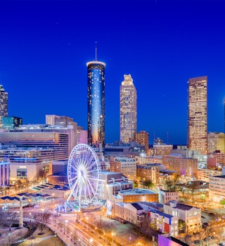 Downtown Atlanta city skyline lit up during twilight.