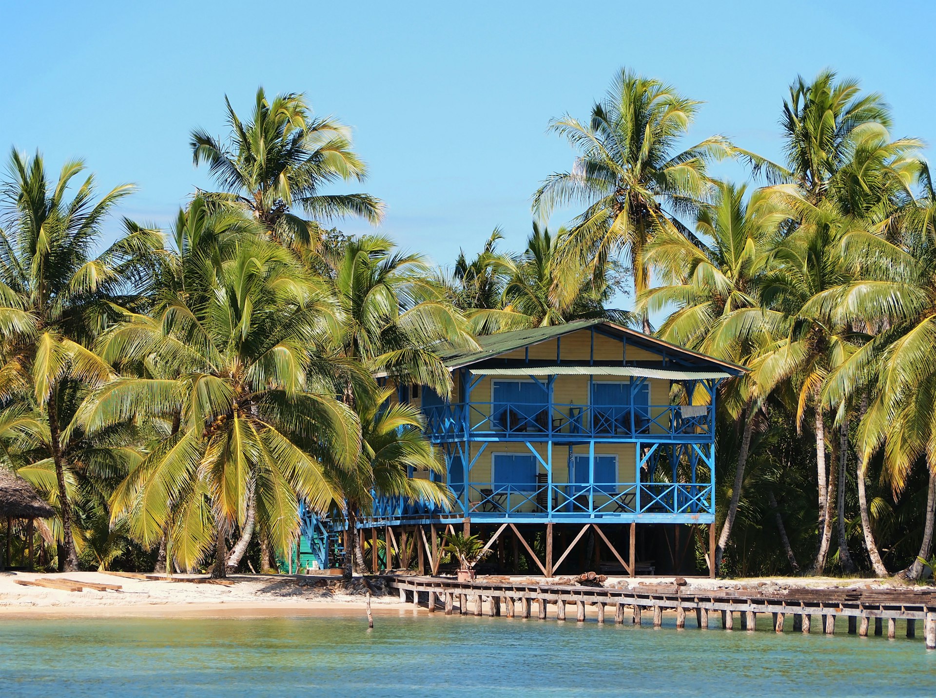 Tropical beach house with coconut trees and a dock, Caribbean side of Panama, Central America