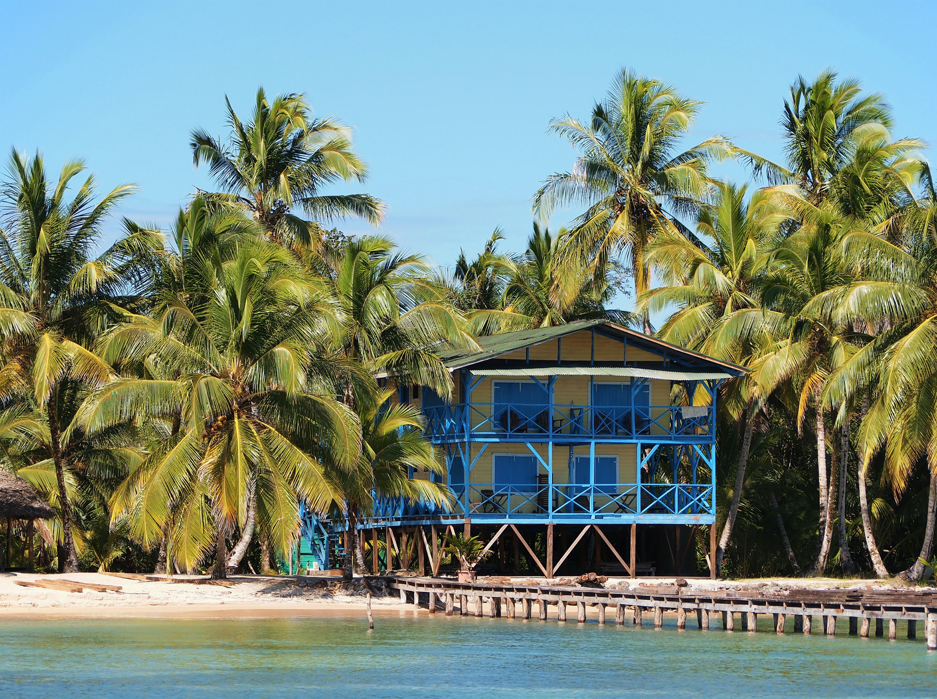 Tropical beach house with coconut trees and a dock, Caribbean side of Panama, Central America