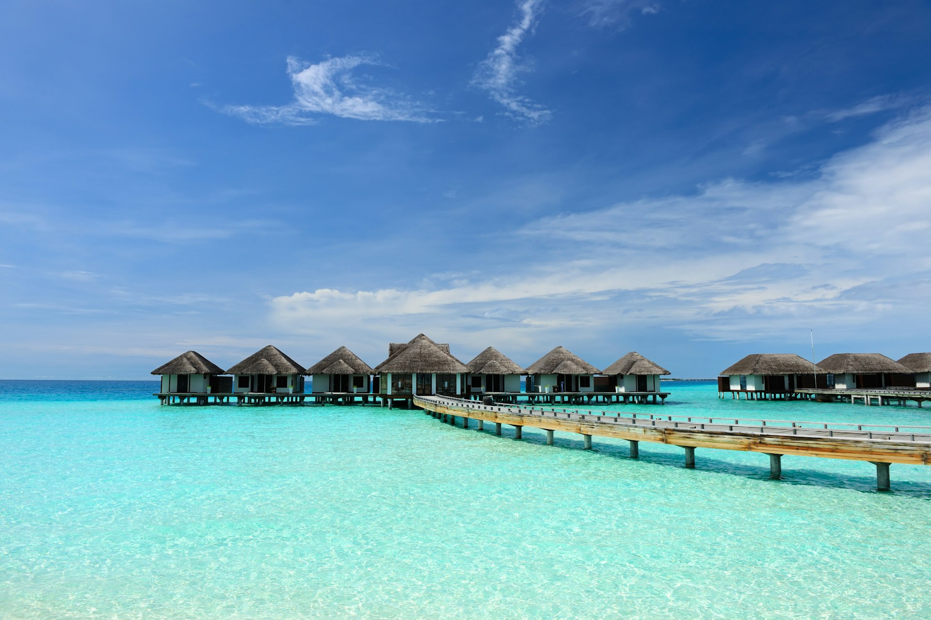 A beautiful beach with over-water bungalows in Maldives 