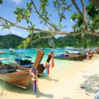 Long tail boats on the beach of one of the Phi Phi Islands, Krabi.