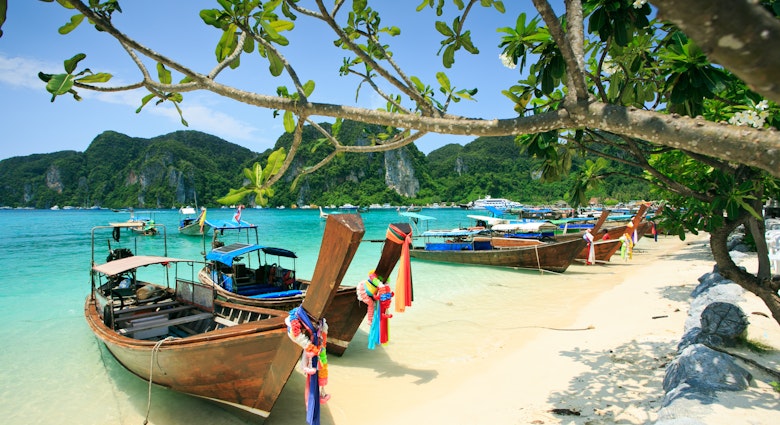 Long tail boats on the beach of one of the Phi Phi Islands, Krabi.