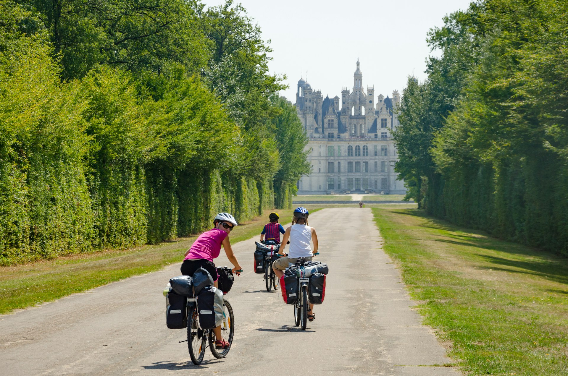 Bikers bicycle touring near Chambord Castle in France, Loire Valley 