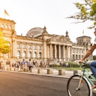 Urban city life with famous Reichstag building in the background in beautiful golden evening light at sunset in summer with retro vintage Instagram style pastel toned filter effect, Berlin, Germany