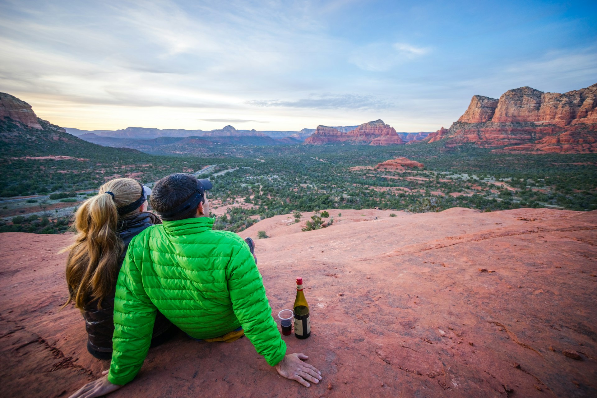 Couple watching a desert sunset with a bottle of wine in Sedona