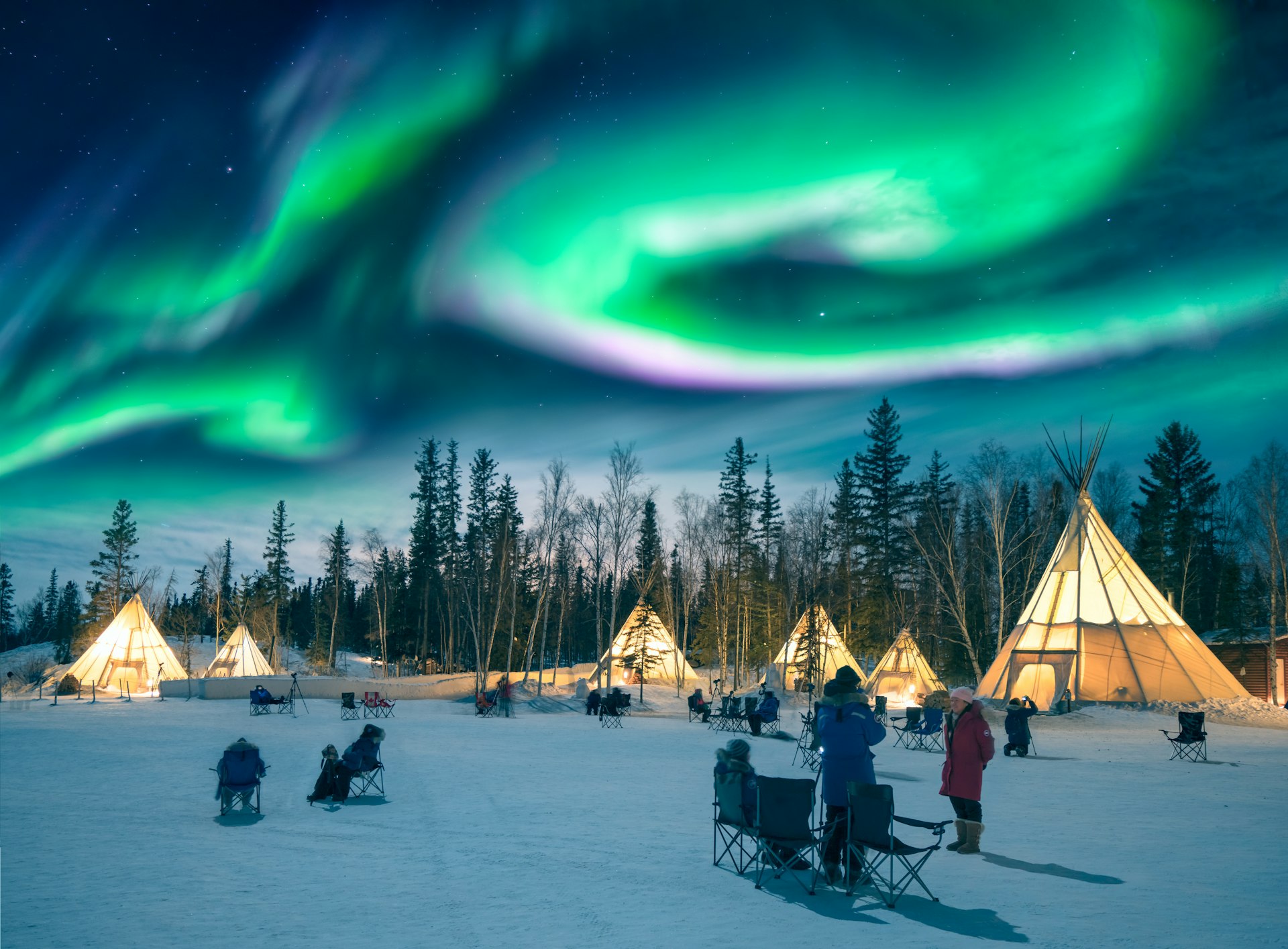 Amazing northern lights dancing over the tepees at Aurora Village