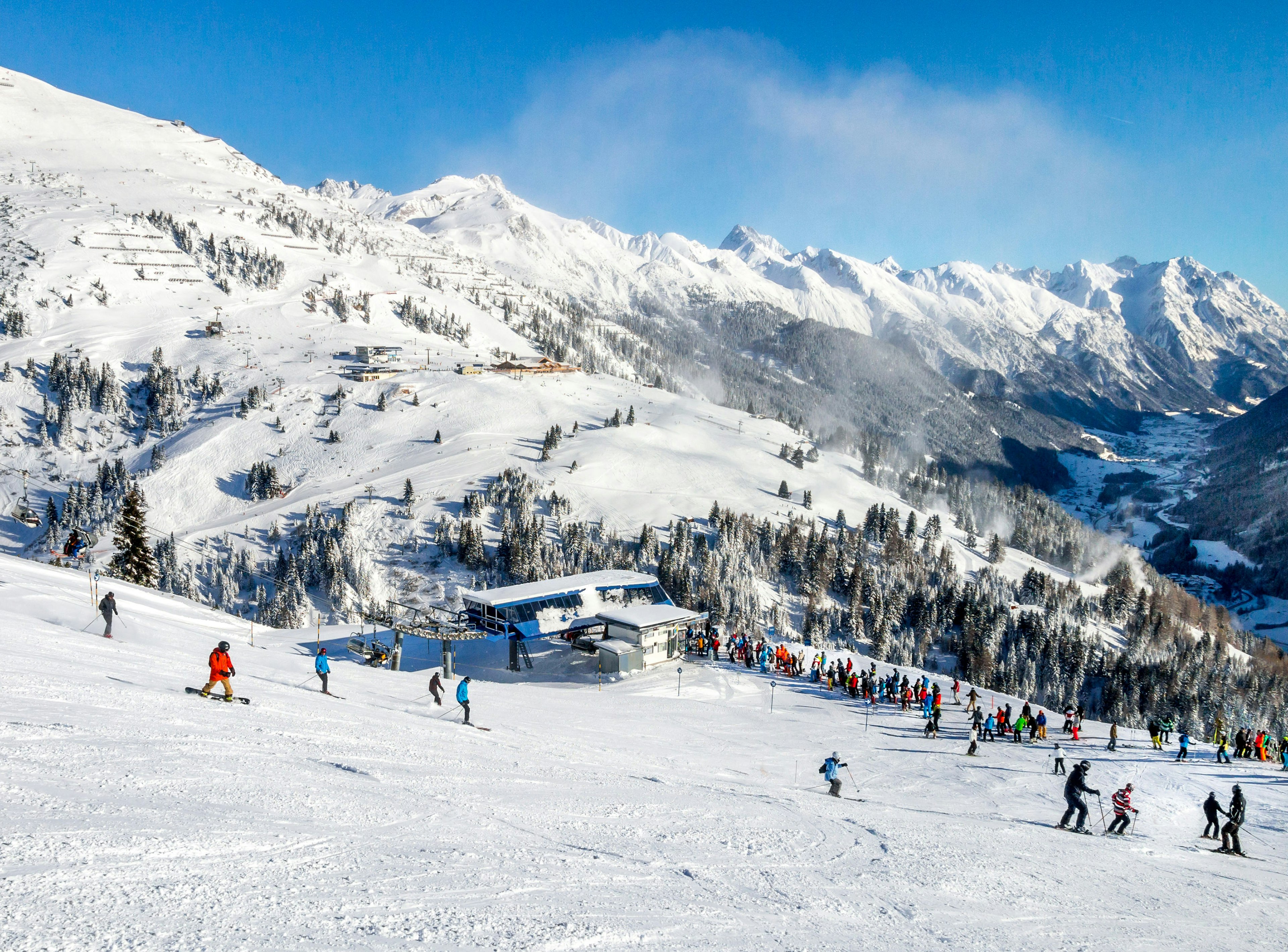 Skiers and snowboarders on the slopes of the St. Anton winter resort.