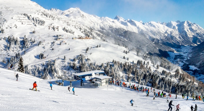 Skiers and snowboarders on the slopes of the St. Anton winter resort.