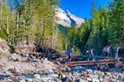 September 25, 2010: four hikers cross a wooden footbridge over the head of Sandy River in Mt. Hood National Forest.