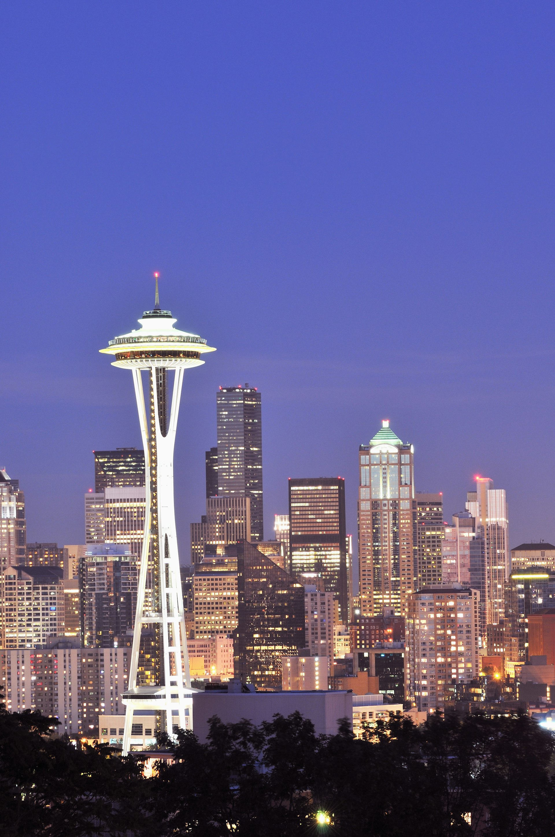 A large UFO-like dish sits on top of tall white legs and dominates the skyline of the city of Seattle