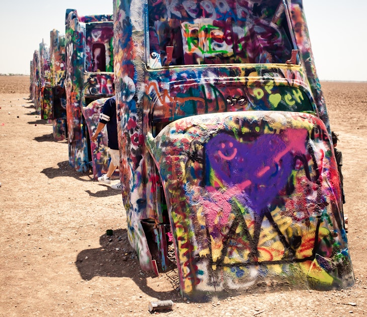AMARILLO, TEXAS - JULY 10: Famous art installation Cadillac Ranch on July 10,2011 near Amarillo, Texas. It was created in 1974 by C. Lord, H. Marquez and D. Michels and consist from 7 buried Cadillacs
